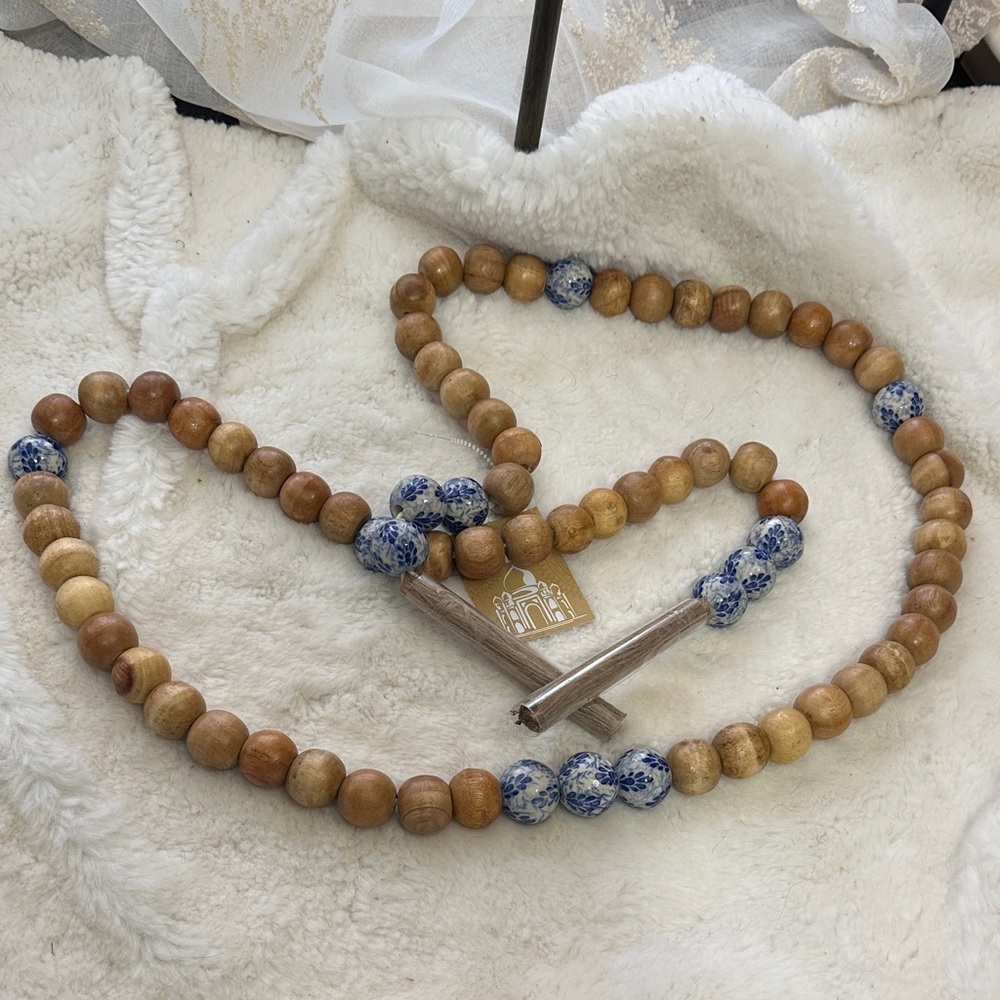 Made in India wooden beaded decor with blue and white ceramic accent beads.